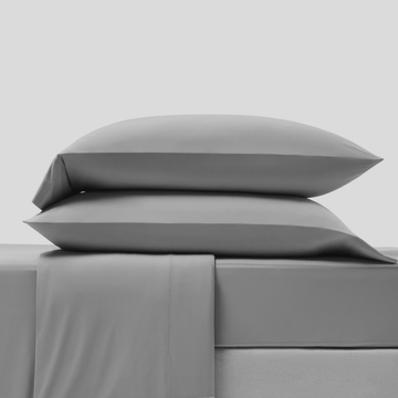 Full gray CoolingCode™ bedding set arranged in a serene bedroom, promoting a refreshed morning wake-up