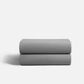 `Gray CoolingCode™ fitted sheet tightly secured on a mattress, showcasing deep pocket design and cooling fabric technology