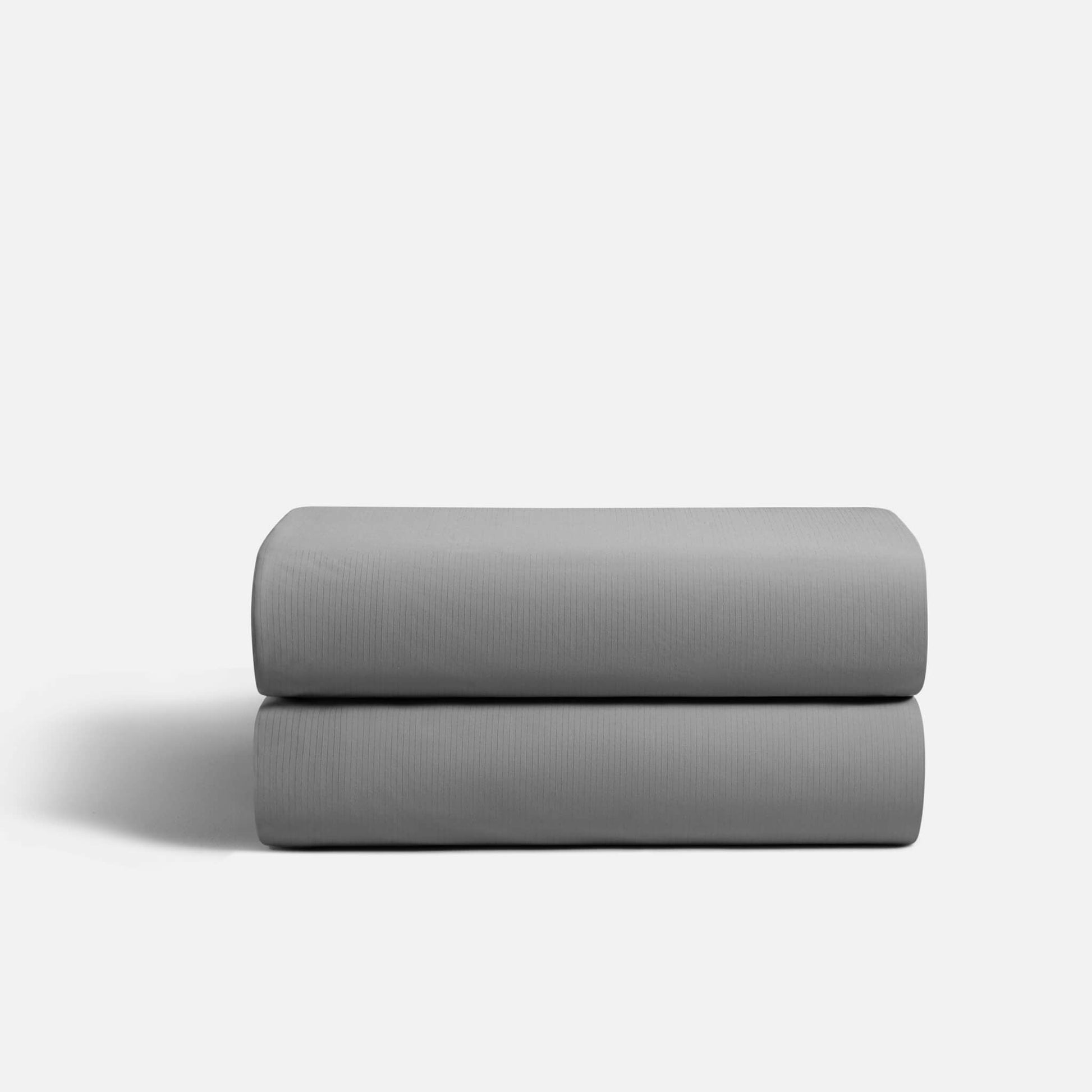 `Gray CoolingCode™ fitted sheet tightly secured on a mattress, showcasing deep pocket design and cooling fabric technology
