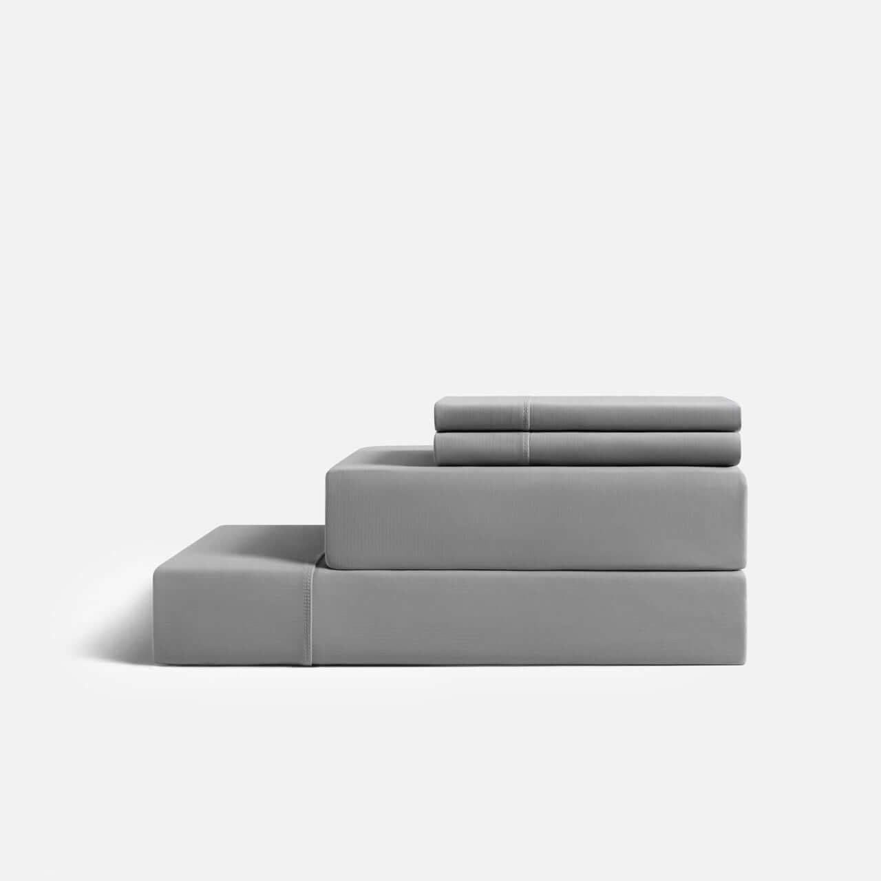 Gray CoolingCode™ sheets set on a bed, showcasing heat-absorbing fabric for cooler sleep and reduced night sweats