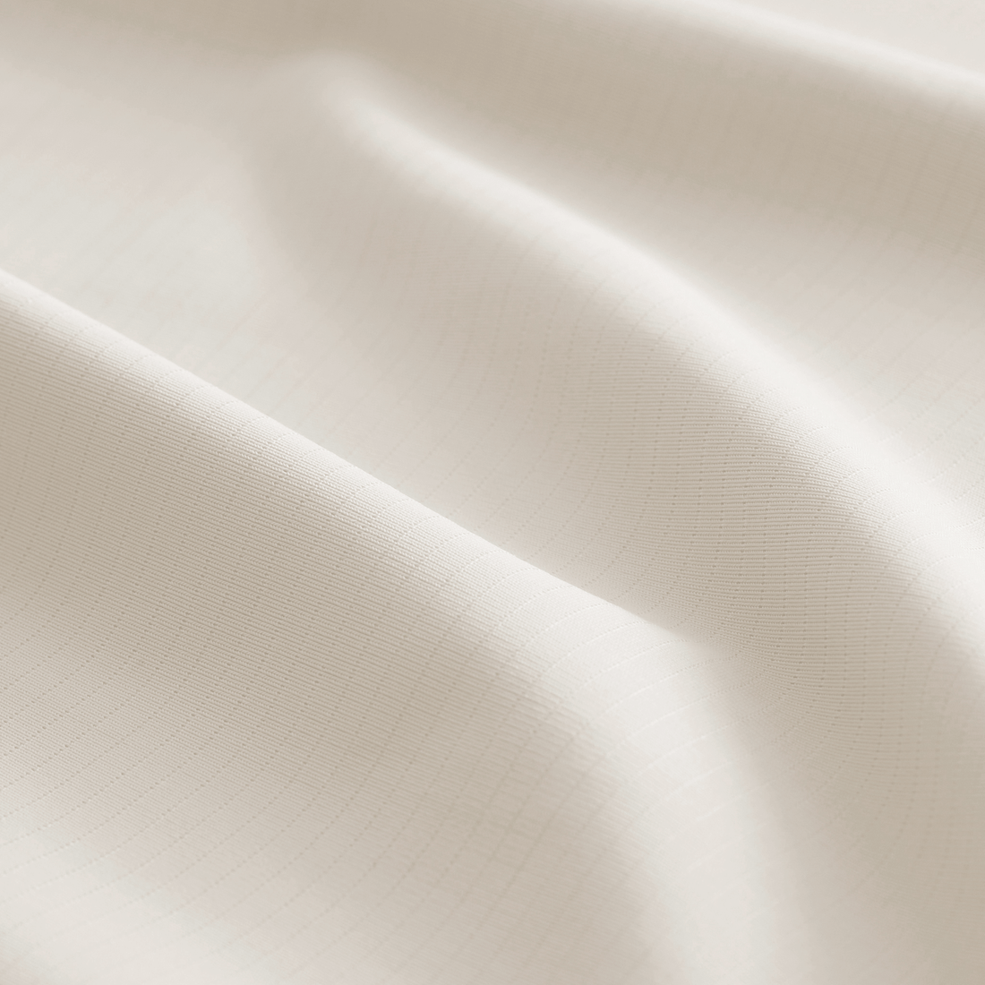 Cream-colored CoolingCode™ sheets on a mattress, demonstrating heat dissipation and comfort