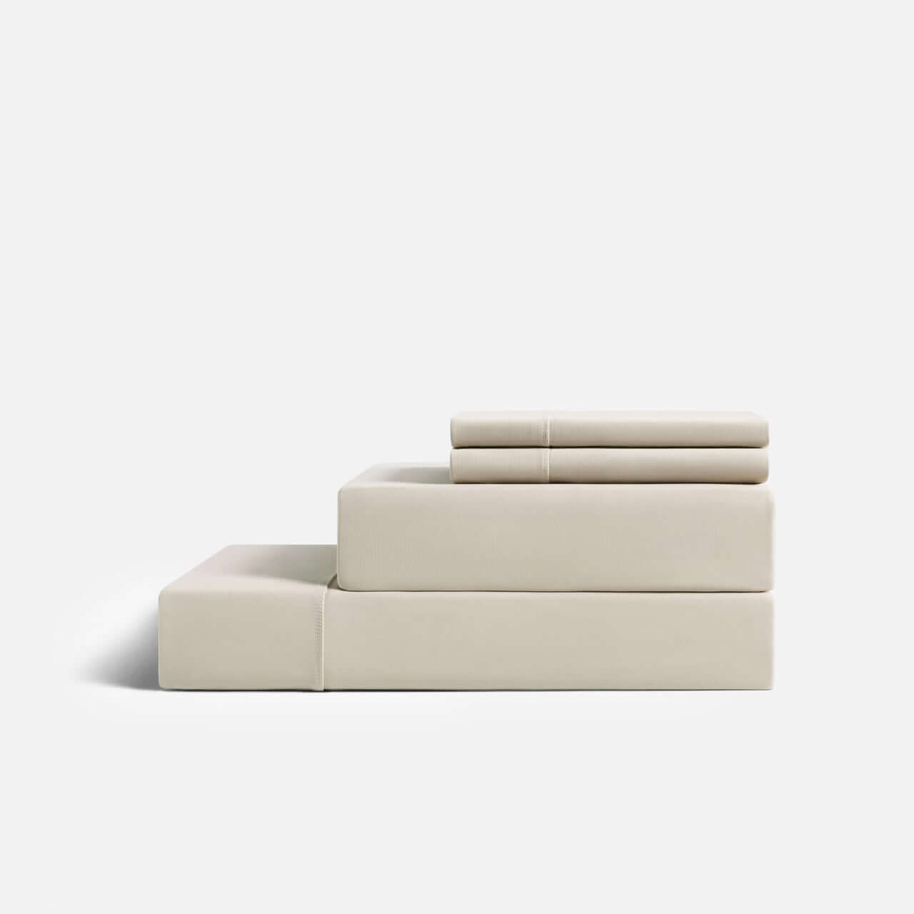 Cream-colored CoolingCode™ sheets on a mattress, demonstrating heat dissipation and comfort