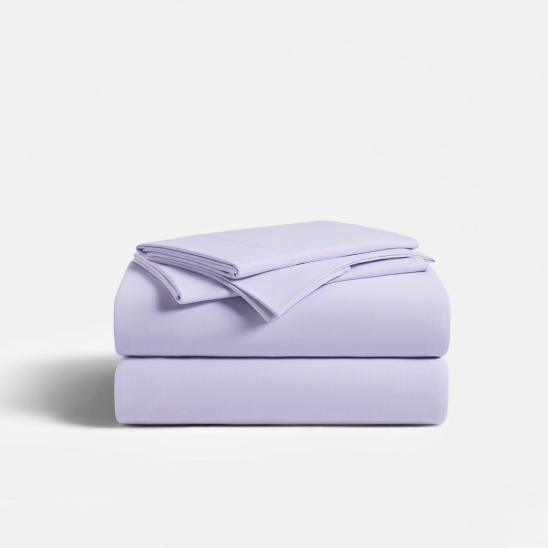 Folded lavender bed sheets on a light gray background