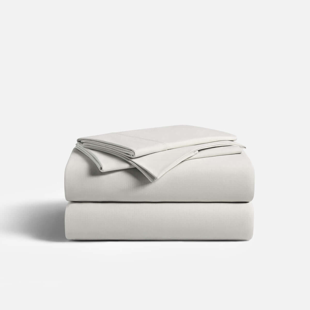 CoolingCode™ fitted sheet bundle featuring a light-colored fitted sheet and two neatly folded pillowcases.