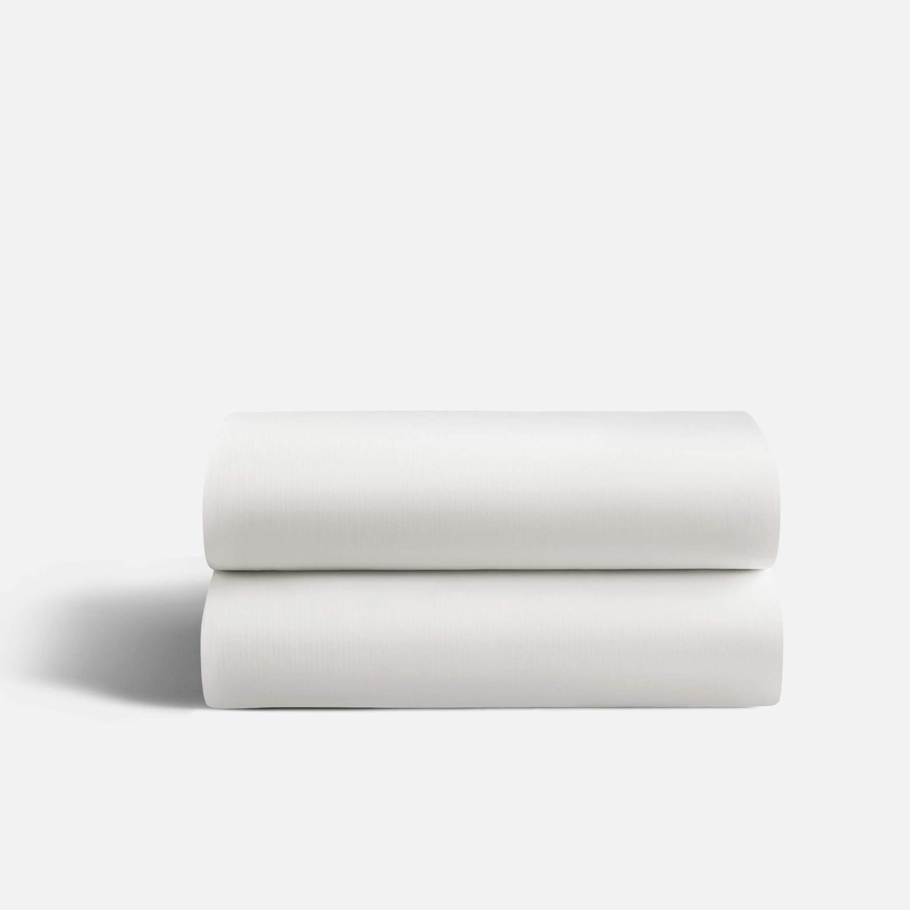 White fitted sheet stretched over a queen-size mattress, showing flexibility and snug fit