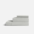 White CoolingCode™ sheets on a bed, clinically tested for cooling efficiency and sweat reduction